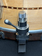 Close-up of a guitar capo attached to a guitar body