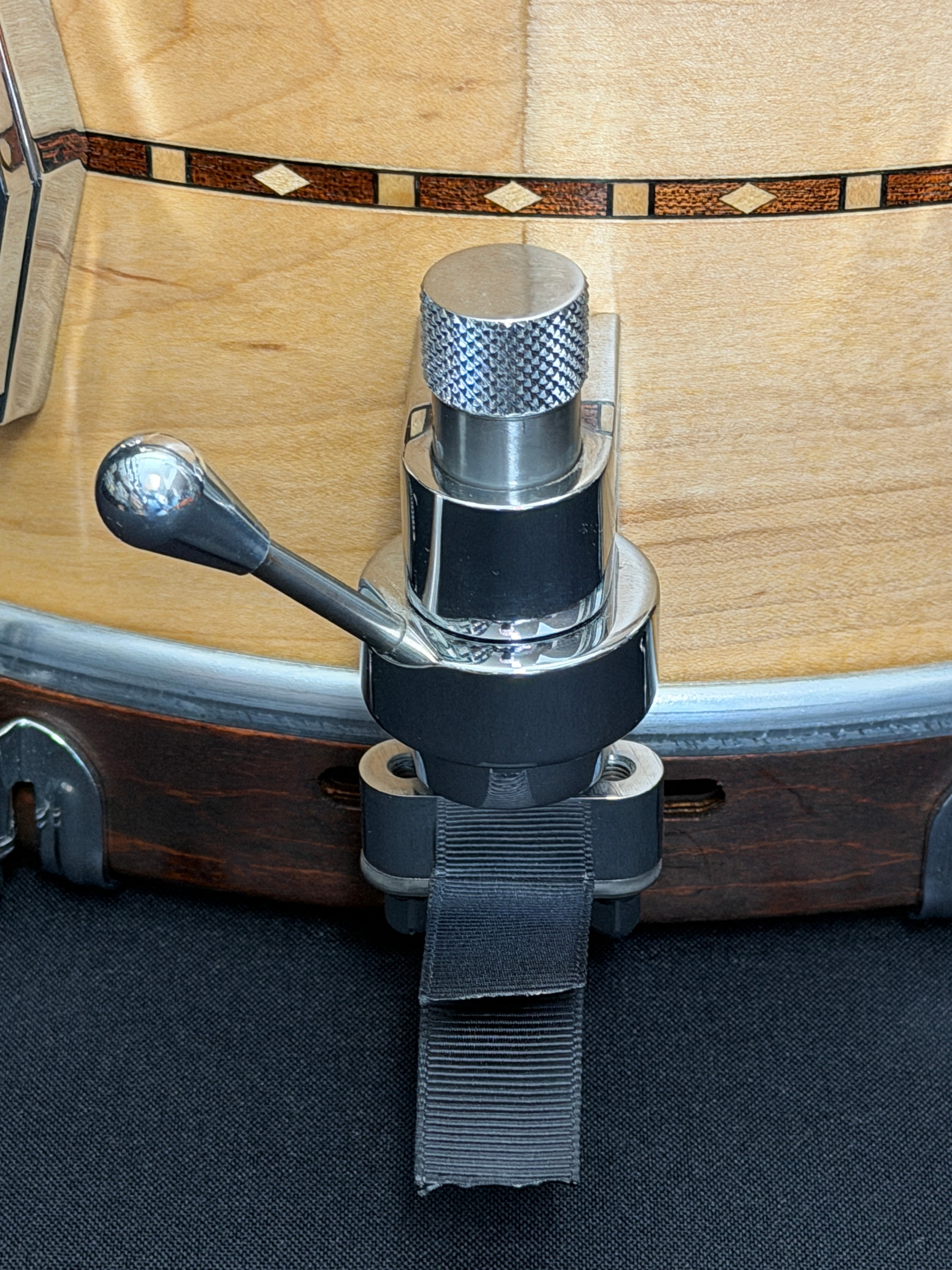 Close-up of a guitar capo attached to a guitar body